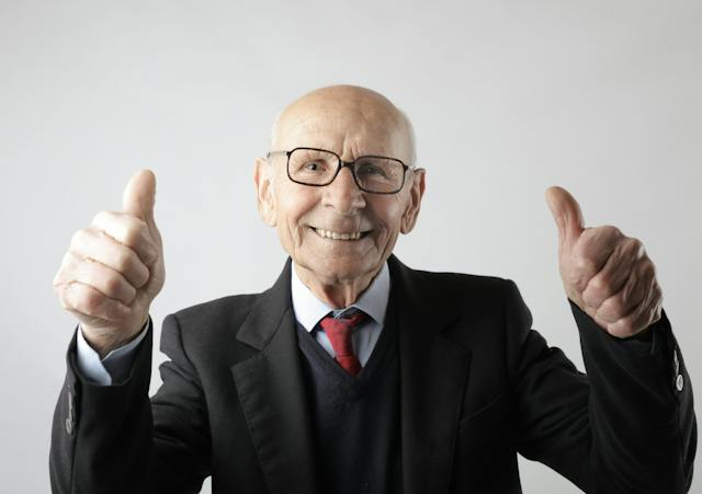 Happy older man with thumbs up featured on a blog post about the advantages of starting business blogs