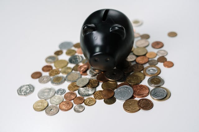 Money outside the piggy bank in a blog post about the benefits of blogging