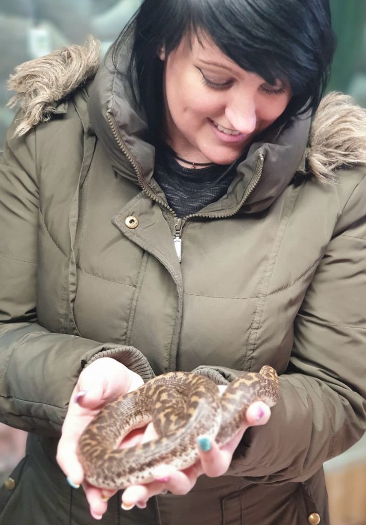 Pixie Greatorex, freelance pet blog writer holding a snake